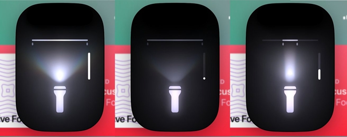 iOS 18 版「动态岛」中的手电筒控制项侧面的竖条显示光线强度。 你可以在方框内外上下滑动来改变亮度。